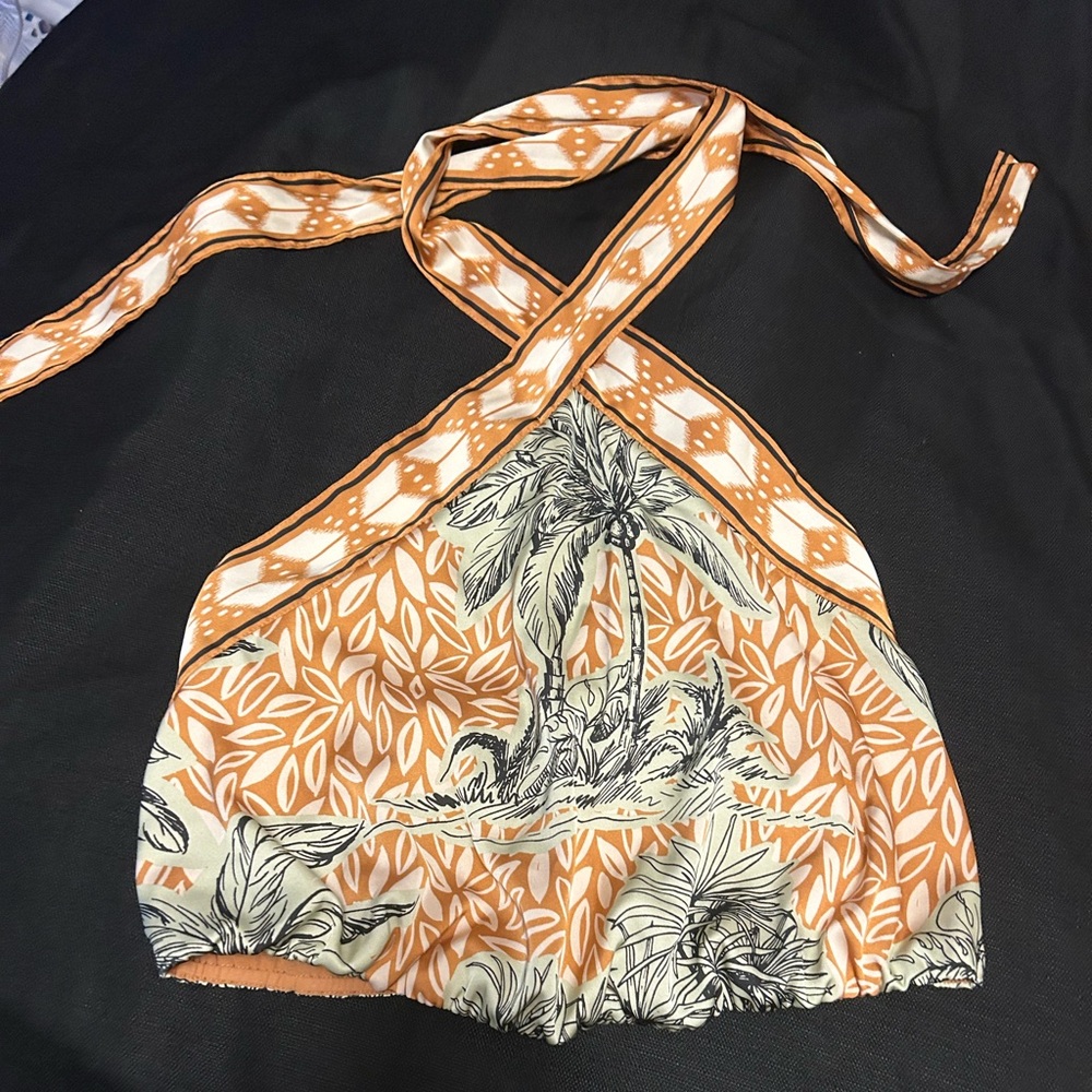 backless pants suit silk,pants are high waisted .The print has  leaves & trees.